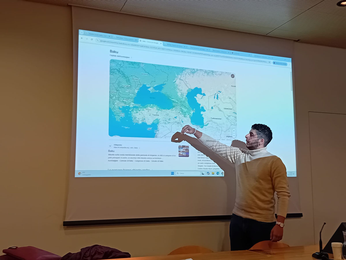 A male participant presenting and showing something on the map