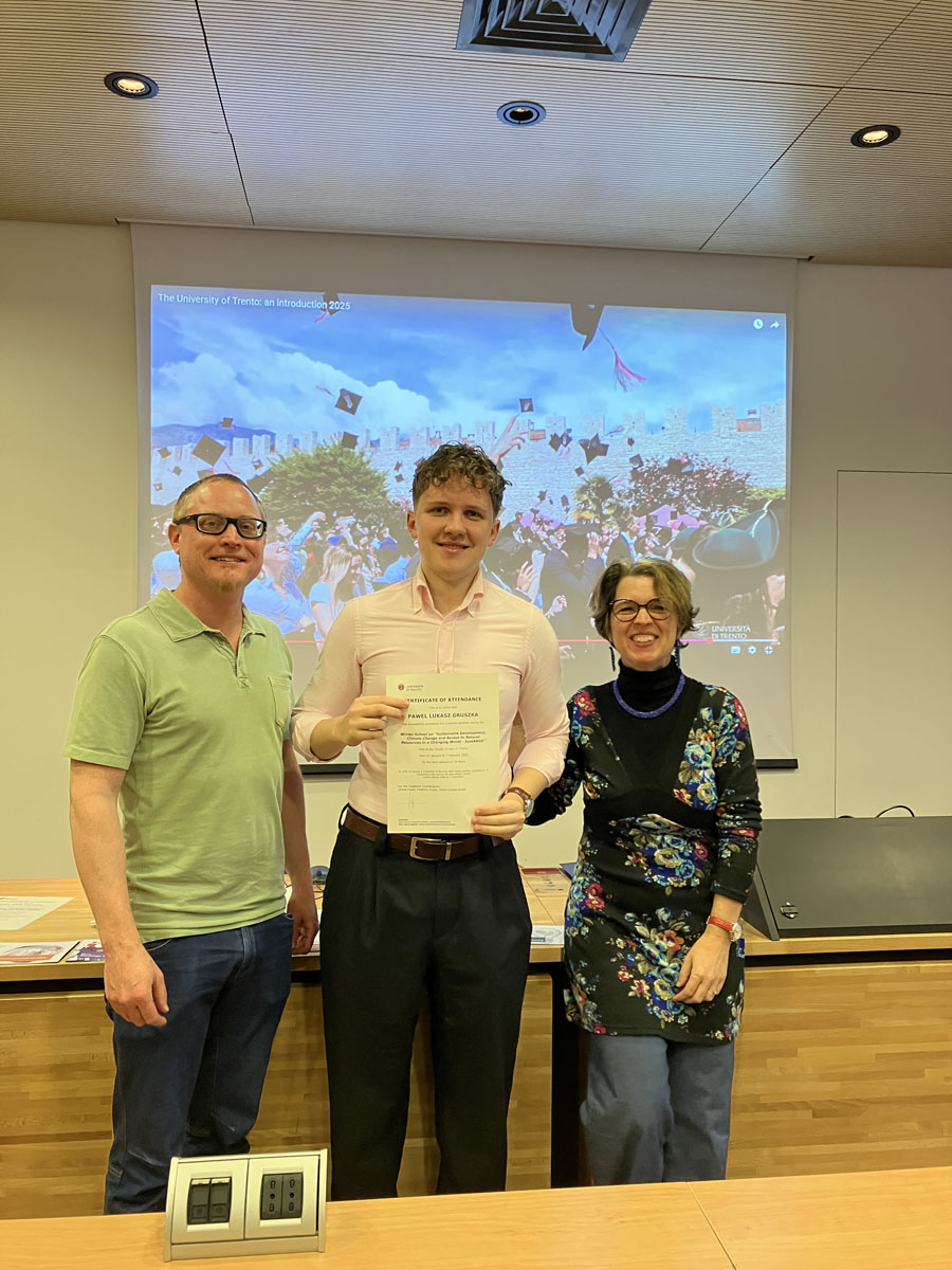 A male participant showing his certificate